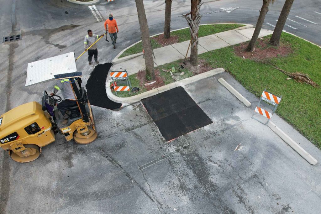 Asphalt Repairs being made to a parking lot in West Palm Beach by 3-D Paving and Sealcoating