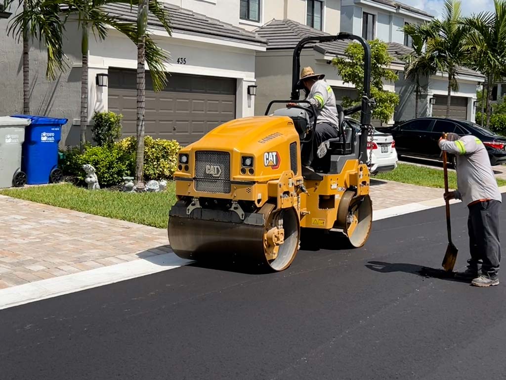Paving contractor in West Palm Beach, FL, 3-D Paving finishes off an asphalt paving job in a residential community using a heavy asphalt roller to compact the fresh layer of asphalt. Looking for asphalt paving in Hollywood? Call 3-D Paving! Looking for Naples paving contractor? Looking for a Fort Myers Paving Contractor?