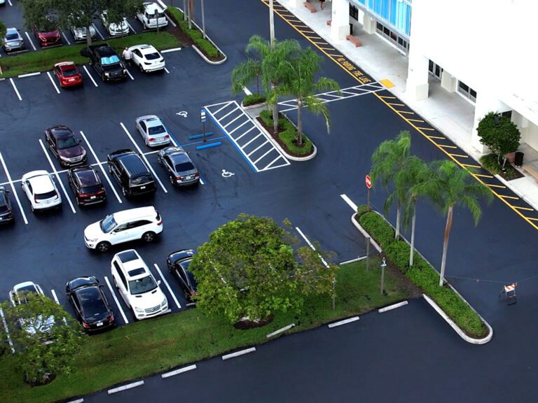 Commercial parking lot contractor sealcoating near me in Davie Florida. Parking Lot restoration specialists, 3-D Paving showing a birdseye view of their sealcoating and striping work at the Tower Shops shopping center in Davie, FL in September of 2022.