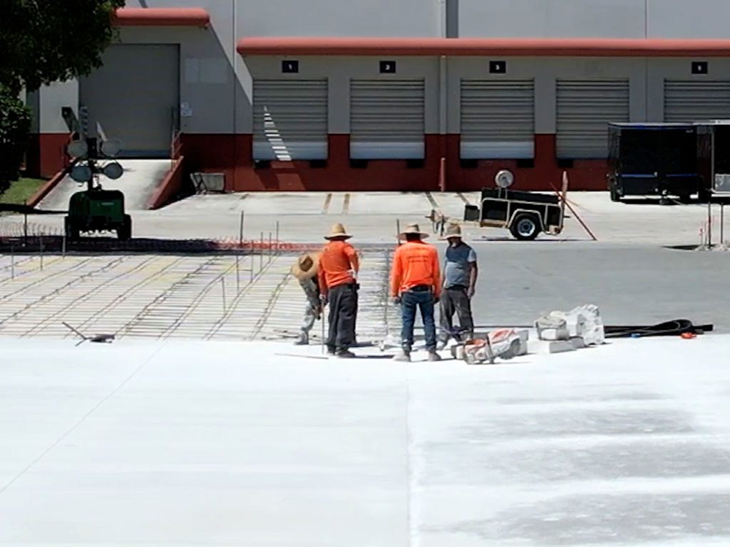 Concrete crew finishing a concrete slab in Pompano Beach in April of 2023.