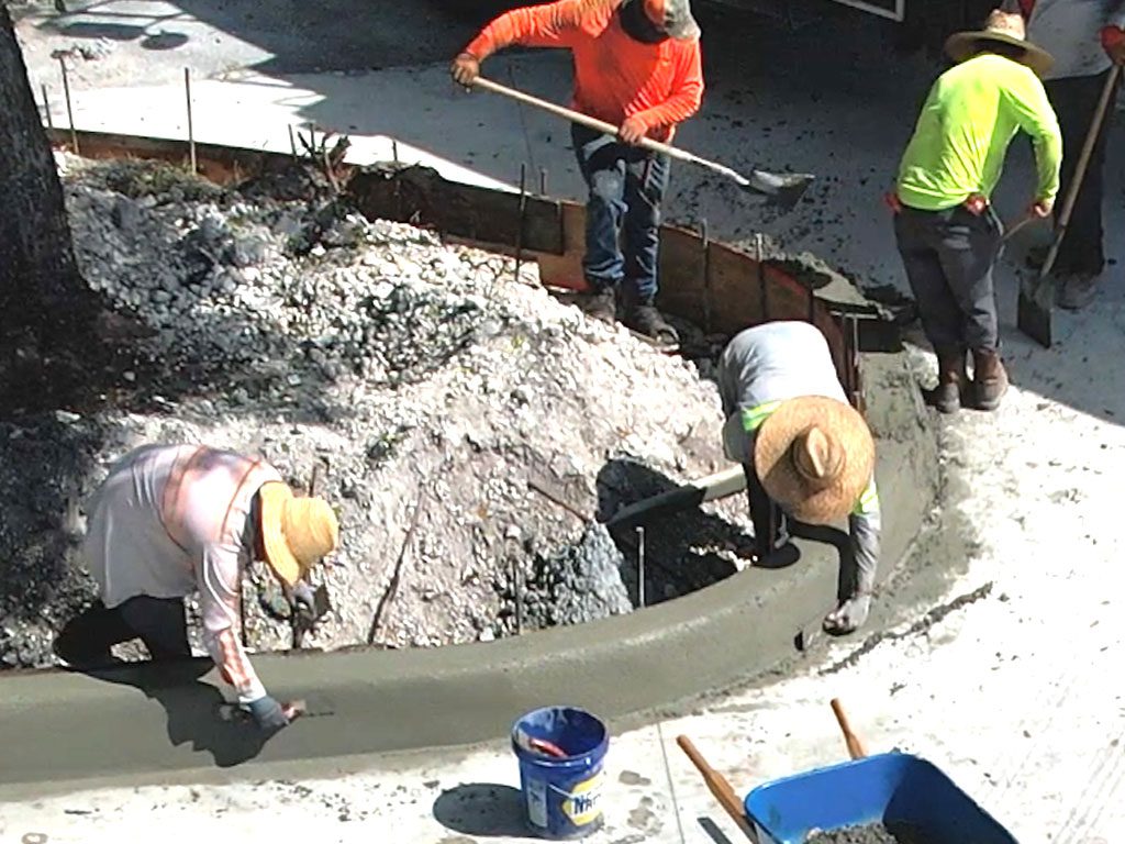 Custom 10-inch concrete curbs being formed by South Florida's trusted concrete company near me.