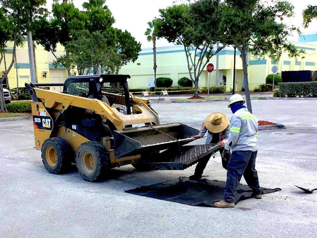 Drainage repair of a catch basin in a parking lot.