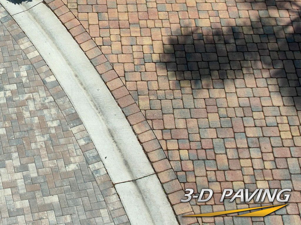 2 different types of pavers or paver brick used to join a driveway to s street newly installed in South Florida by 3-D Paving and Sealcoating in Coral Springs, FL.