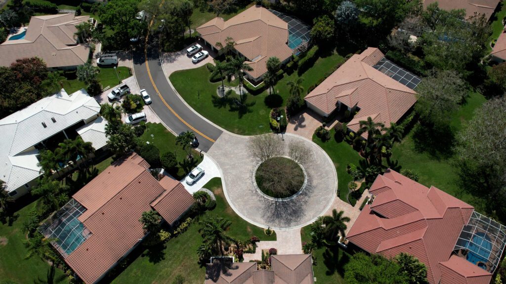 overwatch view of a South Florida HOA cul-de-sac done in paver brick or brick pavers with freshly paved, sealcoating & striped using vinyl striping at a parking lot in Coral Springs, FL by 3-D Paving and Sealcoating. South Florida's Commercial Paving Experts. April 2023.