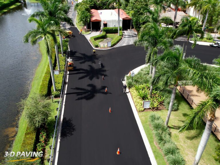 Aerial drone shot from a high altitude directly above a roadway with asphalt paving being installed in Coconut Creek, FL. Photo taken in October of 2023. Work done, paving equipment and personnel by 3-D Paving and Sealcoating. Looking for asphalt paving in Naples, FL? 3-D Paving serves Naples & Ft Myers as well.