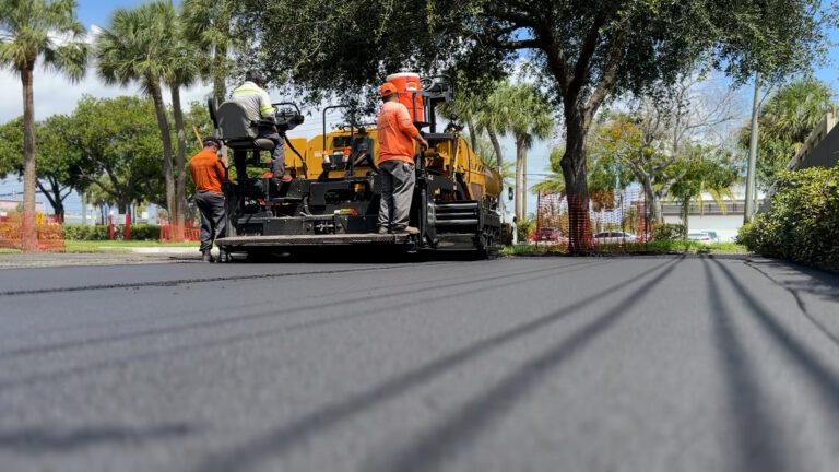 Asphalt Paving Contractor in Deerfield Beach, FL. 3-D Paving and Sealcoating putting down a final lift of asphalt in Sept 2023. Looking for a commercial paving company near me? Call 3-D Paving today.